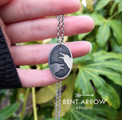 Crows Conversing Oval Pendant