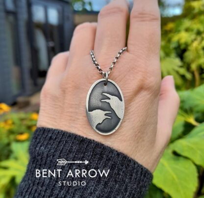 Crows Conversing Oval Pendant